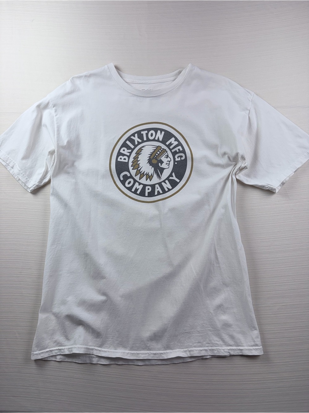 Brixton White Tee with Gold and Black Circular Logo